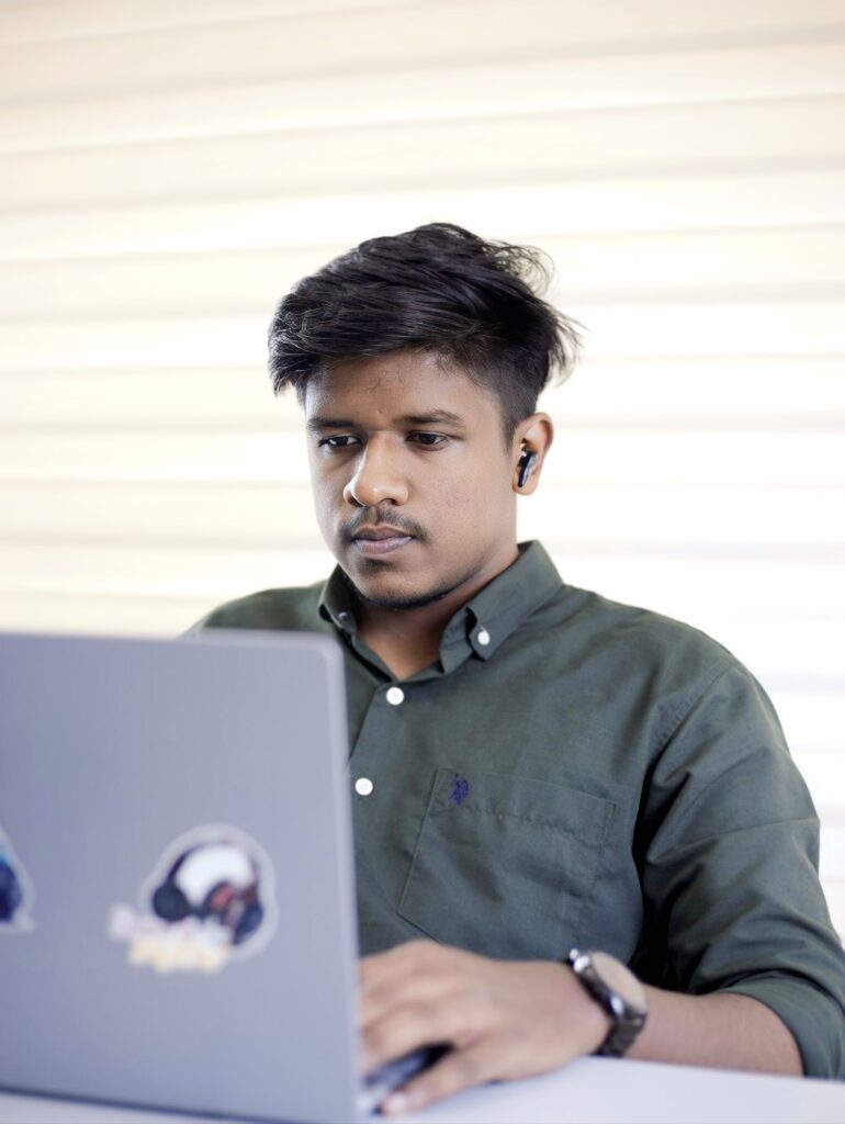 A young man working on a laptop. Best digital marketing freelancer in kerala