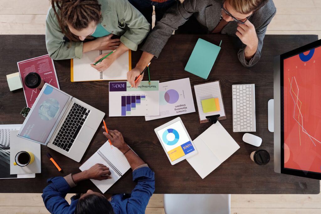 Overhead view of a diverse team collaborating on a project in a modern office setting. best freelance digital marketer in trivandrum